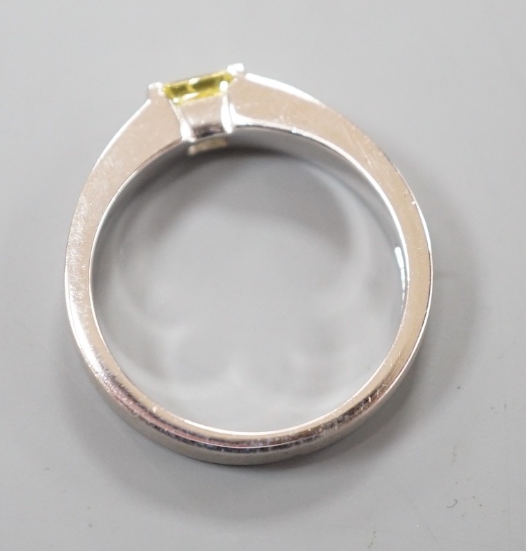 A modern sandblasted platinum and solitaire rectangular cut fancy yellow diamond set ring, size M/N, gross weight 7.2 grams